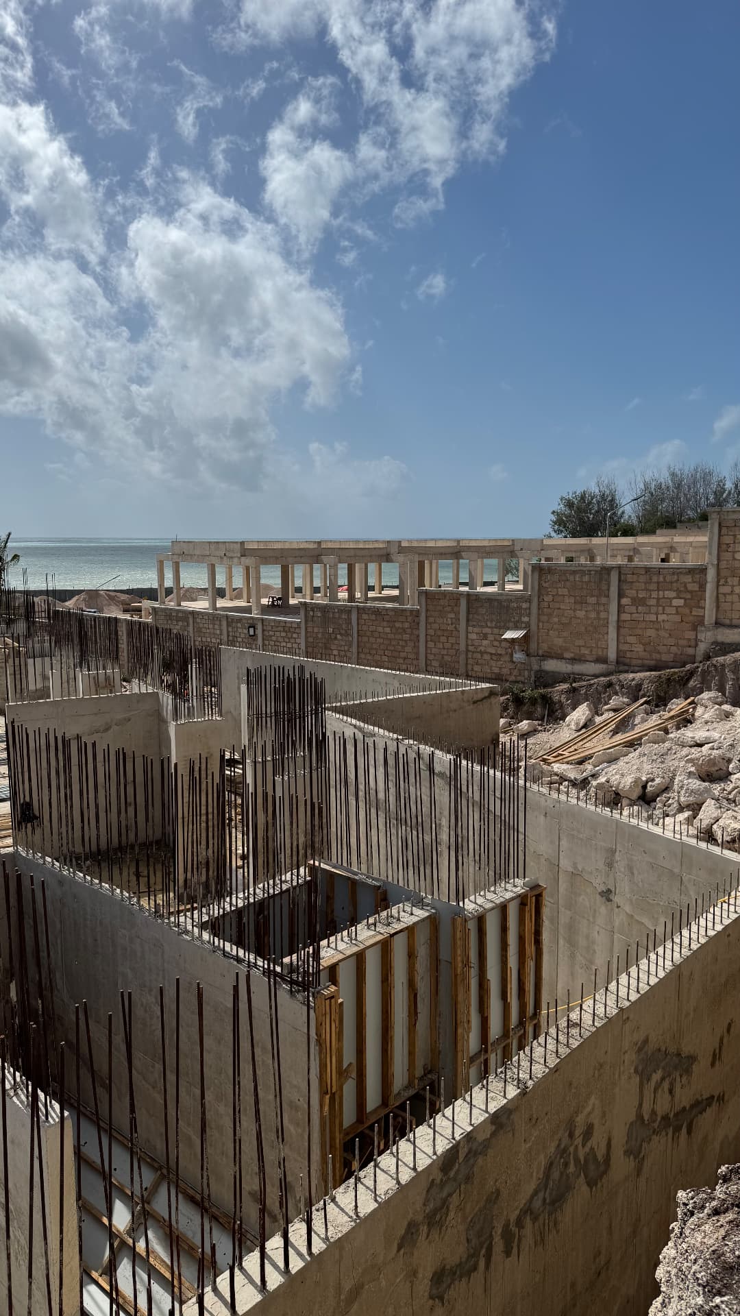 Samawa Beach Resort construction — OU floor reinforcement grid with workers on site